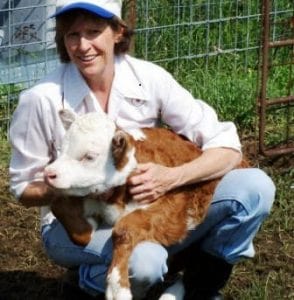 Nancy Gail Falster and her pet mini cow 